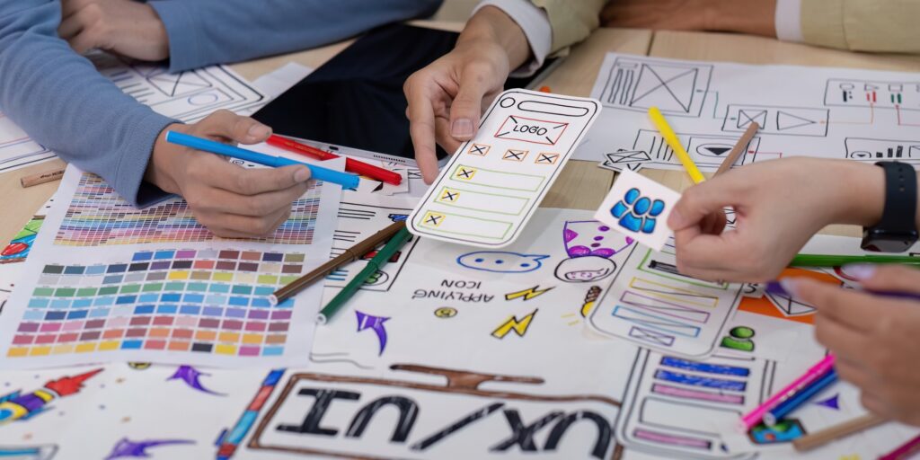 Creative UX Developer and UI Designer Brainstorming Session with Color Palettes, Wireframes, and